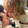 Amari is registered to the contest to win money with this photo: baby, toddler, child, kiss, pacifier, sleeping, closeup, cuddle, soft_light, striped_clothing, face, love, family, indoors, cute, gentle, infant, sibling, warmth, portrait