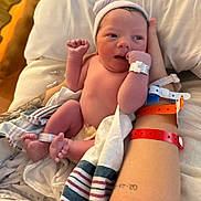 Weston joined the competition — help win amazing prizes! newborn, baby, infant, hospital, blanket, tattoo, arm, wristband, hospital_id, striped_blanket, skin, person, hand, foot, newborn_hat, bed, hospital_room, medical, wrapping_cloth, holding