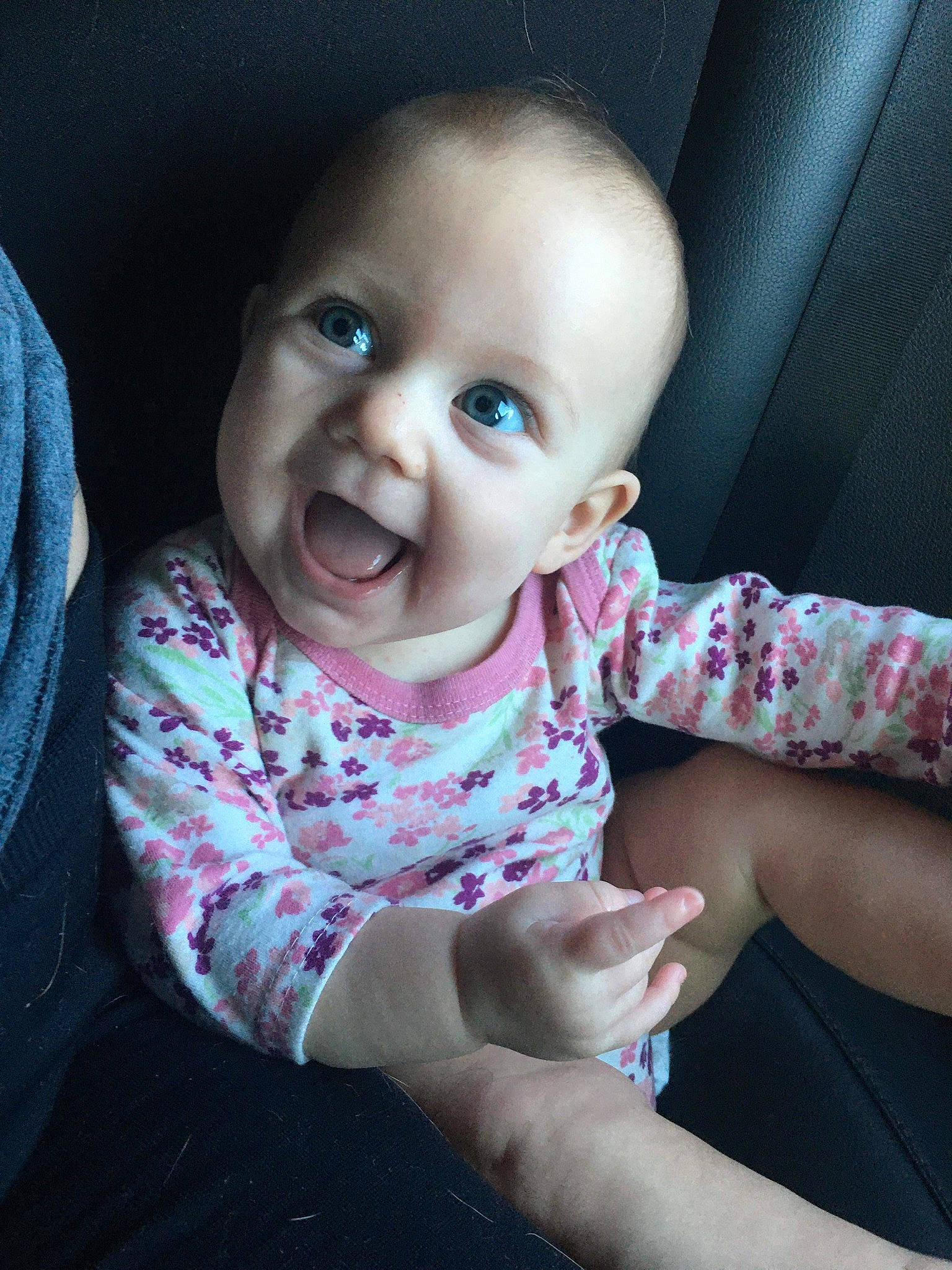 Lucille is registered to the contest to win money with this photo: baby, beauty, cheek, child, chin, eye, face, facial_expression, finger, fun, hand, head, lip, mouth, nose, person, pink, sitting, skin, smile