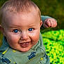 baby, blue_eyes, child, smiling, outdoor, green_blanket, grass, happy, infant, portrait, cute, clothing, person, close_up, face, head, one_person, sitting, young_child, daylight