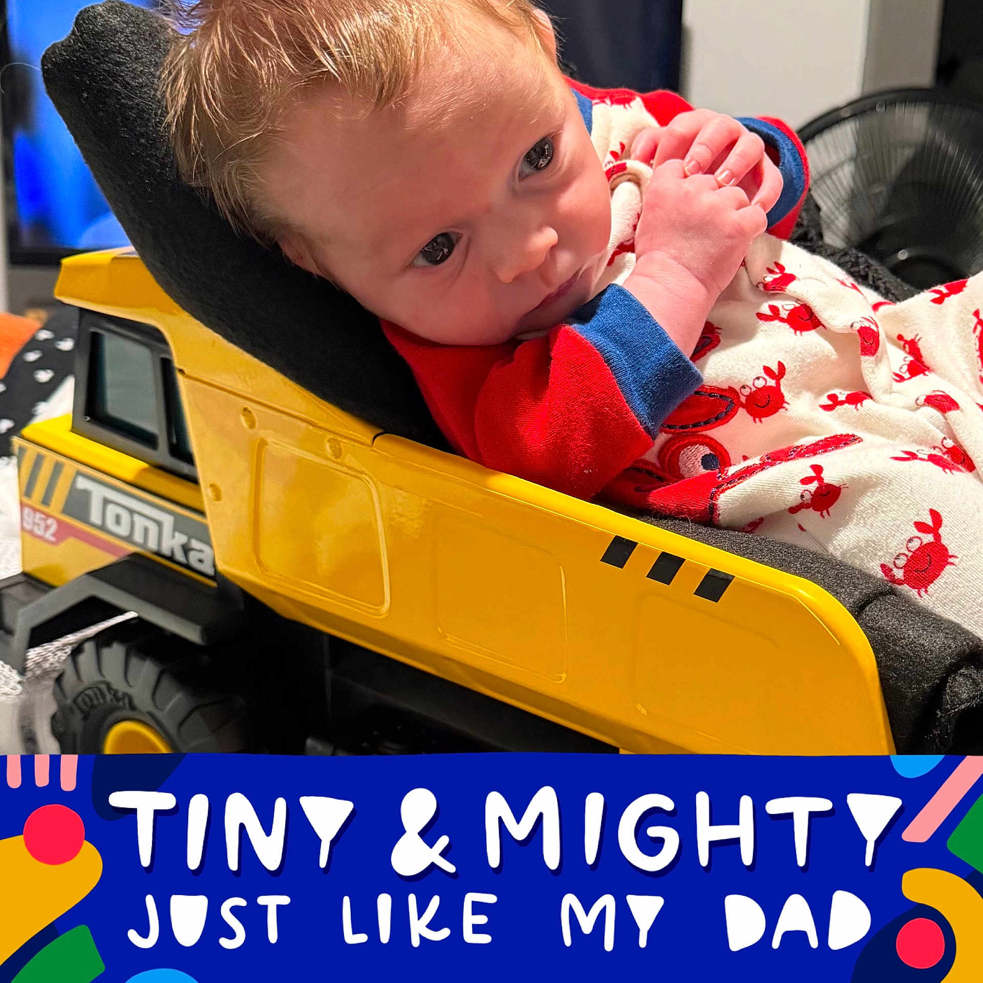Levi Jon Alan is registered to the contest to win money with this photo: baby, child, toy_truck, tonka, onesie, crab_pattern, clothing, face, hands, indoor, furniture, portrait, cute, infant, expression, colorful, text_overlay, playful, soft_light, closeup