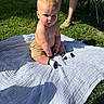 Sutton joined the competition — help win amazing prizes! baby, child, grass, outdoor, blanket, person, legs, socks, shorts, sunlight, nature, summer, greenery, casual, seated, curious, daylight, people, feet, shade