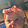 baby, infant, face, headband, pink, bow, child, closeup, curious, eyes, cheeks, indoor, soft_lighting, portrait, cute, expression, young, wearing, clothing, headwear