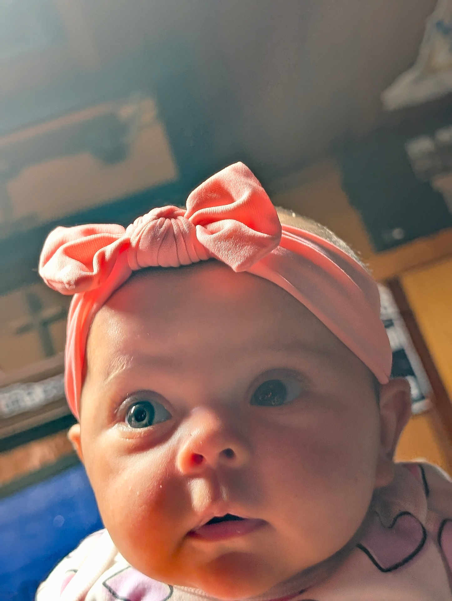 Grace is registered to the contest to win money with this photo: baby, infant, face, headband, pink, bow, child, closeup, curious, eyes, cheeks, indoor, soft_lighting, portrait, cute, expression, young, wearing, clothing, headwear