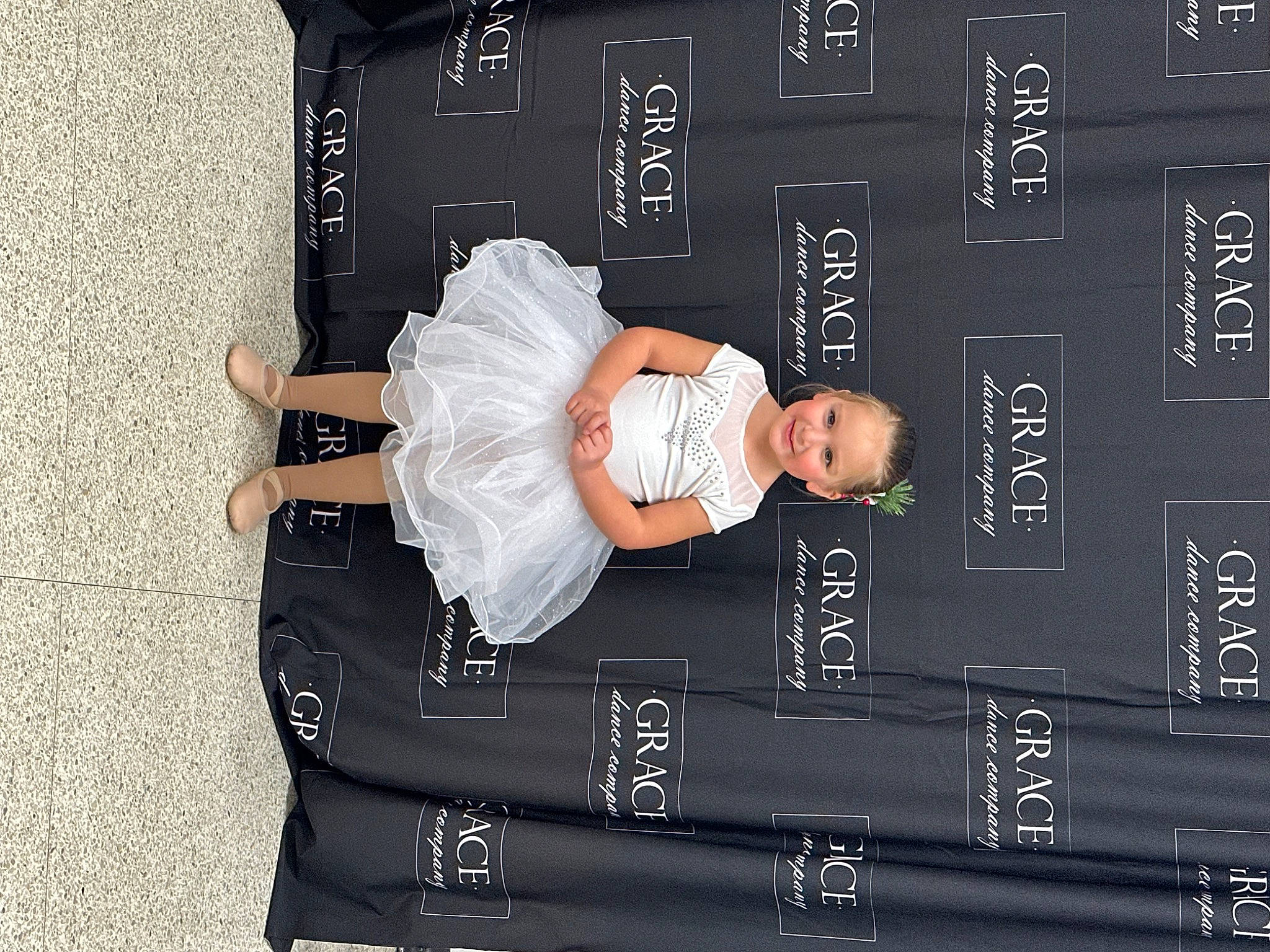 Kinley is registered to the contest to win money with this photo: blackboard, child, elbow, font, hand, joy, person, sitting, sleeve, t_shirt, toddler