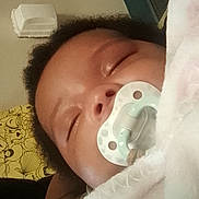 Ayannah joined the competition — help win amazing prizes! baby, sleeping, pacifier, blanket, infant, child, face, closeup, peaceful, resting, cute, soft, indoors, portrait, head, human, young, cozy, comfort, wrapped