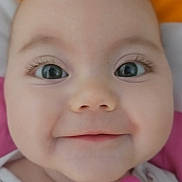 Lennie participe au concours pour gagner de l'argent avec cette photo : baby, close_up, face, smile, eyes, pacifier, infant, cute, child, eyelashes, clothing, pink, white, cute_expression, portrait, adorable, happy, baby_girl, indoors, soft_background