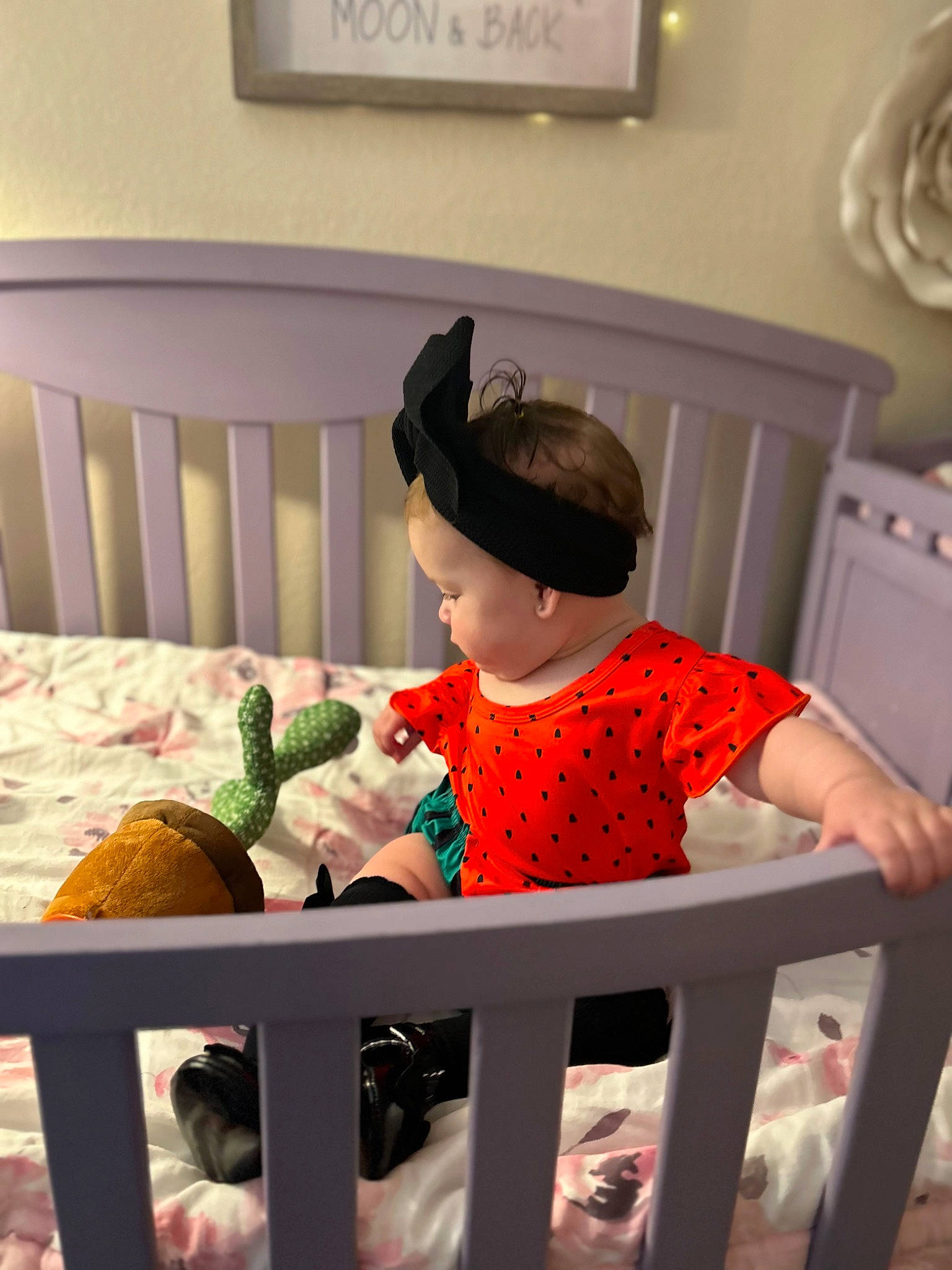 Harlow is registered to the contest to win money with this photo: arm, baby_safety, baby_toddler_clothing, baseball_cap, cap, child, comfort, fence, fun, furniture, happy, hat, headgear, linens, person, picture_frame, sitting, sleeve, t_shirt, textile