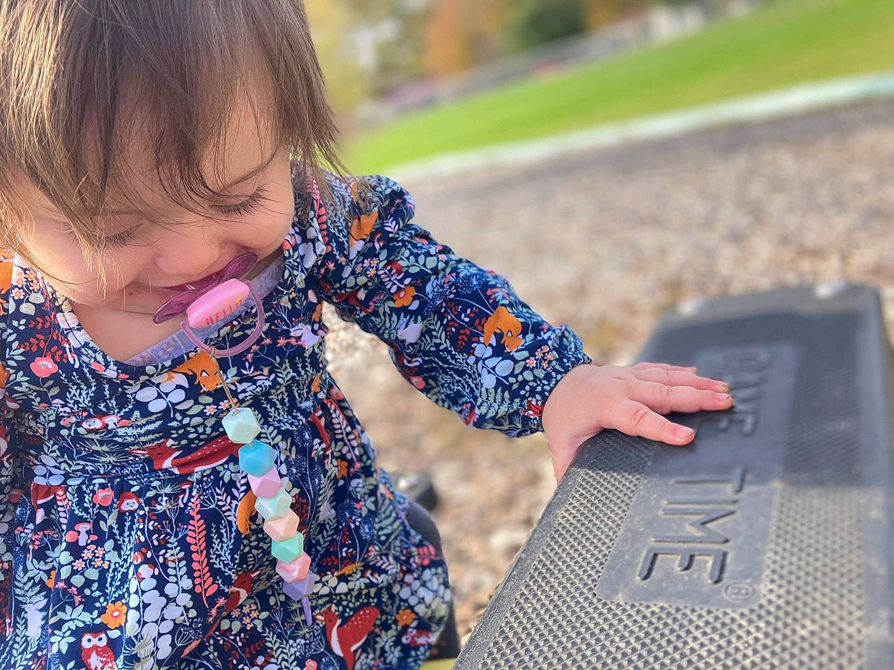 Kinleigh is registered to the contest to win money with this photo: arm, child, denim, dress, electric_blue, finger, fun, grass, hand, happy, leisure, pattern, people_in_nature, person, recreation, sitting, sleeve, street_fashion, summer, toddler