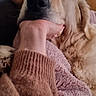 dog, golden_retriever, pet, animal, canine, fluffy, long_hair, cream_coat, black_nose, brown_eyes, close_up, portrait, lying_down, cuddling, human_hand, blanket, cozy, indoors, furniture, relaxed