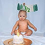 baby, cake, candle, party_hat, celebration, diaper, smile, tassel, background, plate, light_blue, sitting, happy, cute, infant, birthday, half_birthday, food, cream, decor