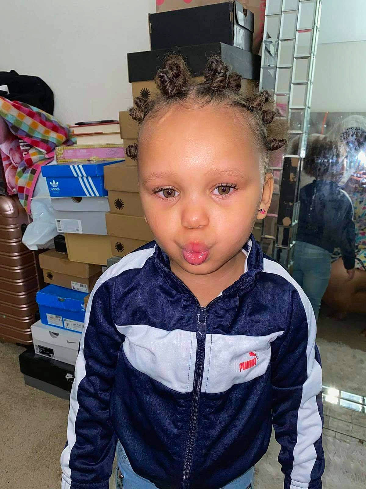 Zaila joined the competition — help win amazing prizes! carton, cheek, child, electric_blue, eyelash, eyewear, fashion_accessory, fashion_design, flooring, fun, hoodie, person, personal_protective_equipment, room, shipping_box, sleeve, t_shirt, toddler, top, vacation