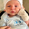 Dominic is registered to the contest to win money with this photo: baby, newborn, infant, hat, mittens, clothing, blue, cute, face, portrait, hand, person, closeup, expression, newborn_clothing, indoor, soft_light, child, apparel, baby_garment