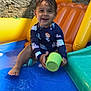 blue, child, colorful, cup, green, happy, inflatable, orange, outdoor, play, pool, sitting, smiling, stone_wall, summer, toddler, toy, water, wet_hair, yellow