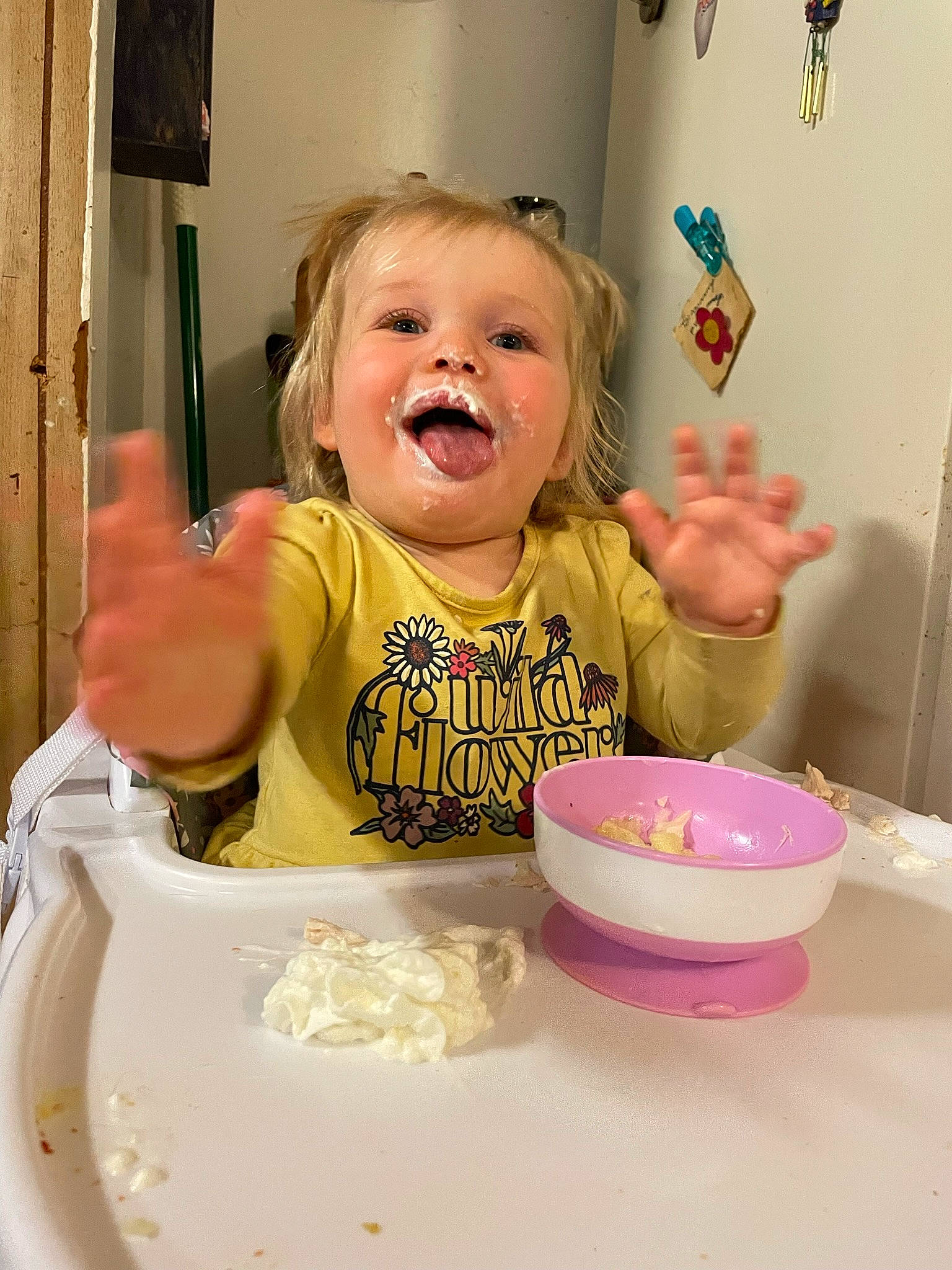 Isabella is registered to the contest to win money with this photo: bowl, chair, child, cuisine, dishware, drinkware, face, facial_expression, food, food_craving, fun, happy, person, pink, plate, serveware, smile, t_shirt, table, tableware