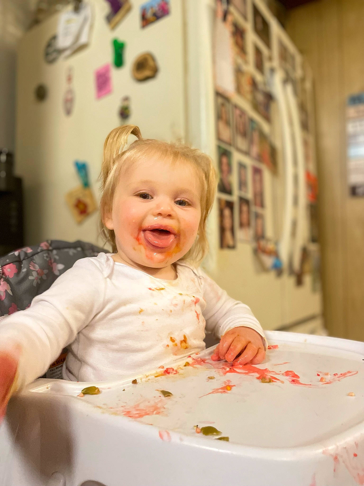 Isabella is registered to the contest to win money with this photo: baby, baby_toddler_clothing, chair, child, comfort_food, dishware, eating, event, food, fun, happy, party, person, picture_frame, plate, room, smile, t_shirt, table, tableware