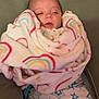 Lillian is registered to the contest to win money with this photo: baby, blanket, rainbow, sleepy, cushion, pajamas, stars, cozy, wrapped, infant, child, face, soft, fabric, indoor, cute, comfort, resting, person, portrait