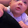 Lillian joined the competition — help win amazing prizes! baby, infant, face, hand, clothing, onesie, curious, indoor, person, skin, arm, head, child, portrait, closeup, young, expression, cute, resting, looking_up