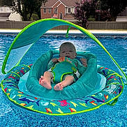 Lillian joined the competition — help win amazing prizes! baby, pool, floatie, water, swimming_pool, sunshade, infant, outdoor, summer, residential, house, trees, blue, colorful, relaxing, child, safety, vacation, sunny, leisure