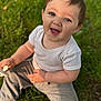 Jaxson joined the competition — help win amazing prizes! baby, child, smiling, grass, outdoor, blue_eyes, pacifier, white_shirt, grey_pants, sitting, happy, cute, sunlight, nature, portrait, young_child, grass_background, casual_clothing, baby_toy, daylight