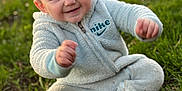 Jaxson is registered to the contest to win money with this photo: baby, child, smiling, sitting, grass, outdoor, nike, clothing, fleece, cute, happy, face, person, nature, green, young, infant, portrait, playful, casual