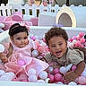 Penelope is registered to the contest to win money with this photo: children, toddlers, ball_pit, pink, white, playground, smiling, laughing, baby, girl, boy, curly_hair, hair_bow, dress, collared_shirt, indoor, outdoor, toys, playtime, portrait