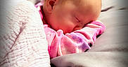 Kayleigh is registered to the contest to win money with this photo: baby, sleeping, blanket, bed, pink_clothing, infant, cozy, peaceful, child, soft, nap, portrait, indoors, head, face, toddler, rest, cushion, warm, comfort