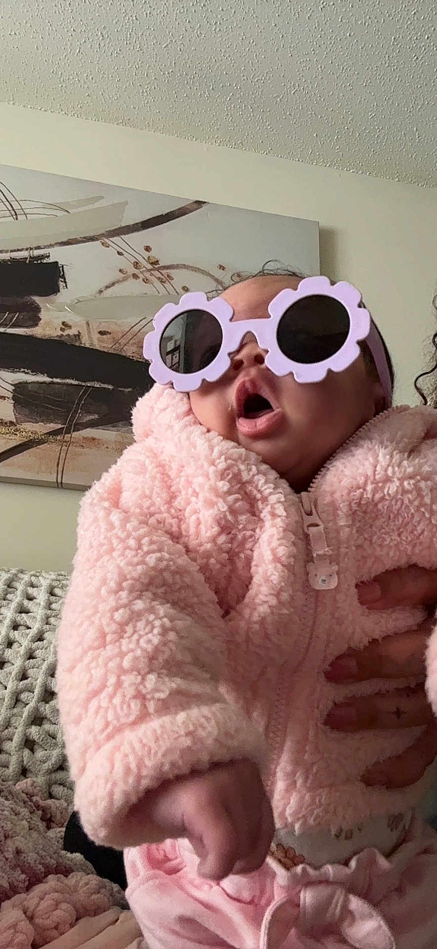 Billie joined the competition — help win amazing prizes! baby, child, pink_jacket, sunglasses, indoor, hand, cozy, knitted_blanket, abstract_art, expression, person, cute, fashion, portrait, soft_texture, clothing, home, infant, funny_glasses, warm