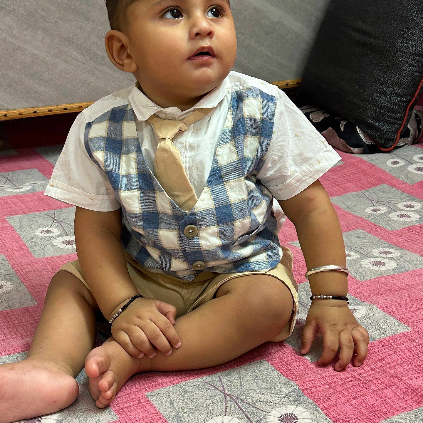 Areeb joined the competition — help win amazing prizes! bedspread, bracelet, child, curious, cute, fabric, feet, floor, hands, indoor, pattern, pillow, pink, portrait, shorts, sitting, tie, toddler, vest, young