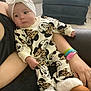 Paisley is registered to the contest to win money with this photo: arm, baby, boots, bow, chair, child, clothing, cozy, cute, furniture, hand, headband, indoor, infant, leopard_print, mickey_mouse, minnie_mouse, person, sitting, wristband