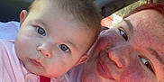 Paisley is registered to the contest to win money with this photo: baby, car_interior, casual, child, closeup, face, happy, heart_pattern, holding, hoodie, nose_ring, parking_lot, person, pink_clothing, portrait, red_hair, smile, sunlight, trees, window