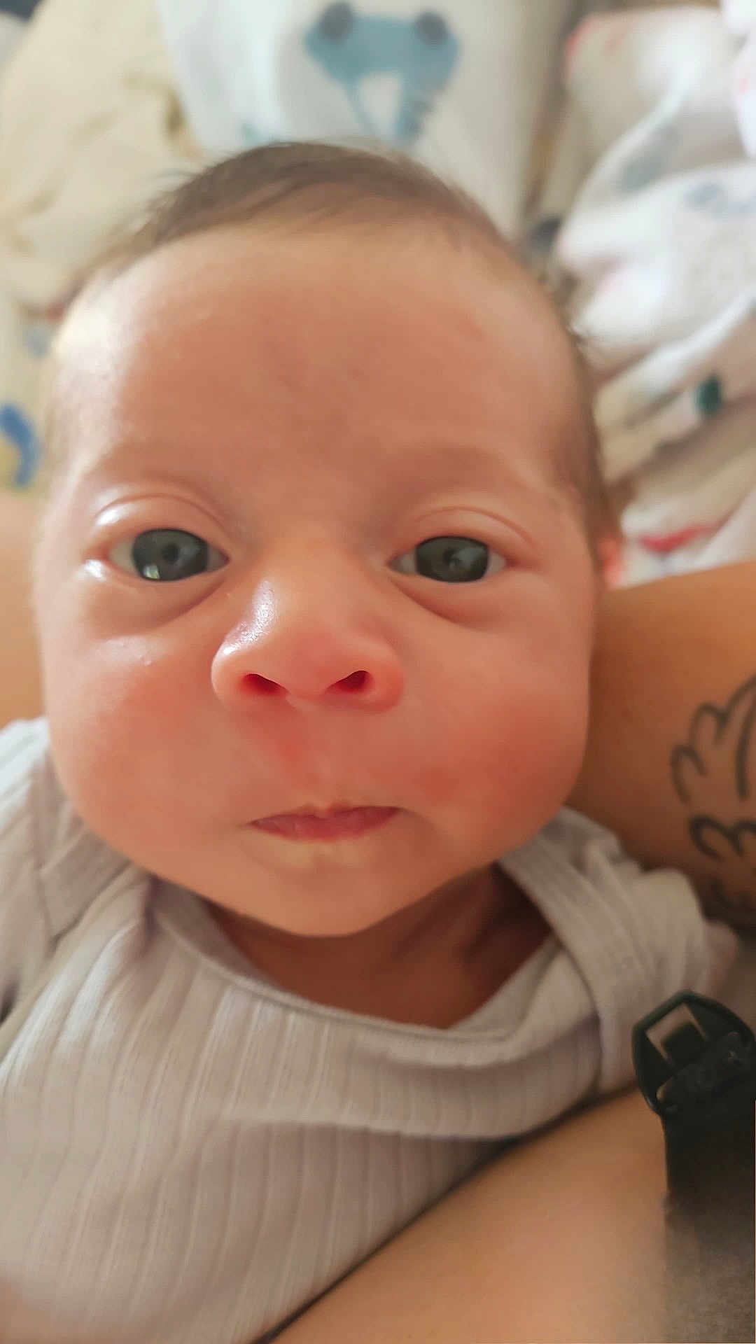 Elijah joined the competition — help win amazing prizes! baby, newborn, face, closeup, infant, skin, eyes, mouth, person, portrait, expression, cute, human, child, clothing, tattoo, arm, indoors, soft, warm