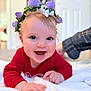 Coralie is registered to the contest to win money with this photo: baby, smiling, flower_crown, red_clothing, blanket, indoor, happy, child, portrait, cute, toddler, hand, face, head, skin, infant, eyes, expression, soft, blurred_background