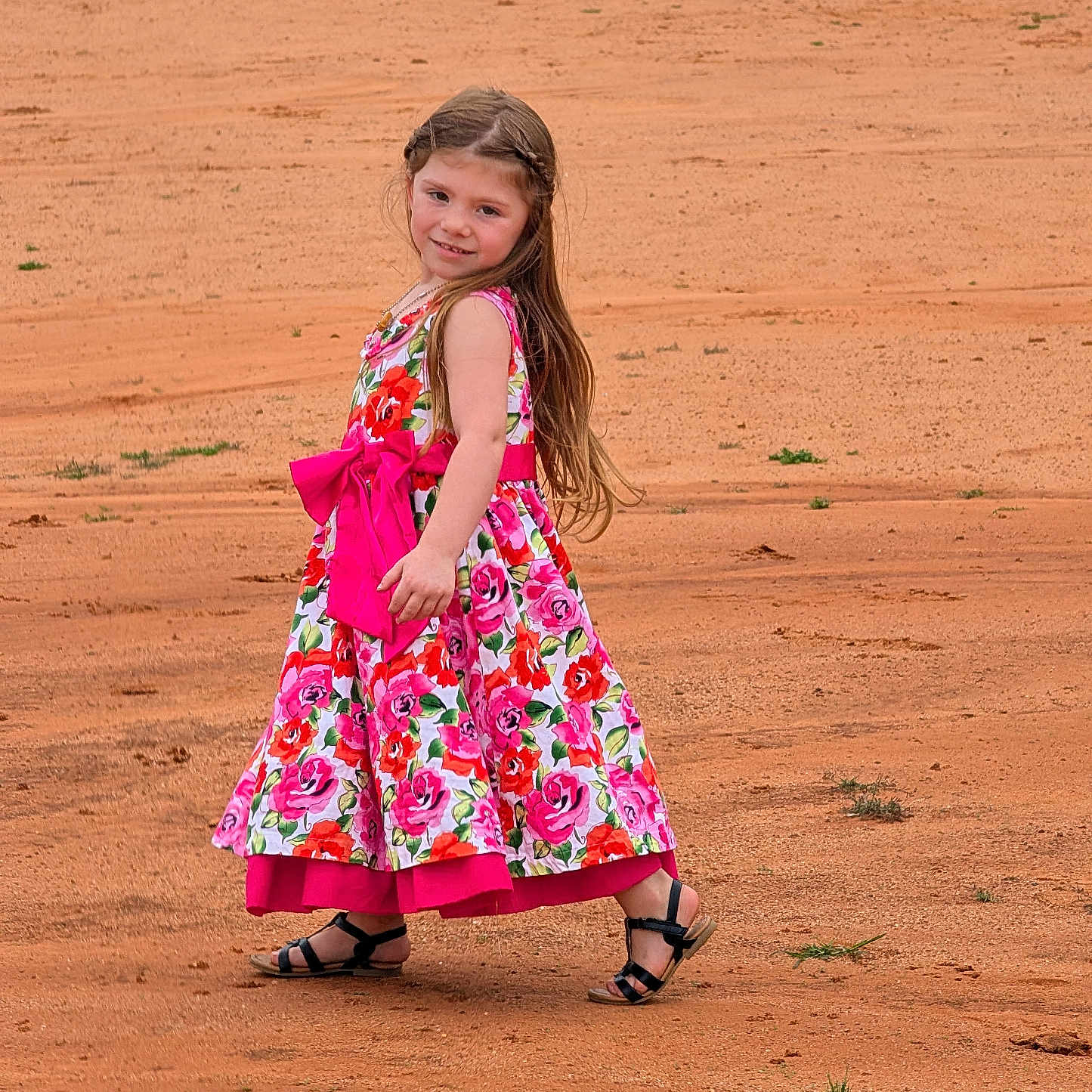 Adalyn joined the competition — help win amazing prizes! child, girl, dress, floral, bow, sand, field, outdoor, smile, long_hair, sandal, playful, young, person, fashion, cute, happy, nature, portrait, summer