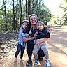 Johnny joined the competition — help win amazing prizes! woman, child, children, outdoor, forest, trees, dirt_path, daylight, family, smile, hugging, nature, casual_clothing, young, toddler, walking, happy, people, park, candid
