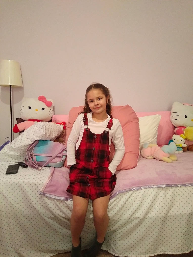 Nevaeh joined the competition — help win amazing prizes! comfort, dress, event, fashion_design, happy, human_leg, joy, knee, leg, linens, person, pillow, pink, plaid, shoulder, sleeve, stuffed_toy, tartan, textile, thigh