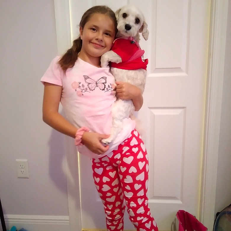 Nevaeh is registered to the contest to win money with this photo: animal, canine, child, clothing, dog, door, face, female, footwear, girl, head, pajamas, pants, person, pet, photography, portrait, puppy, shoe, t_shirt