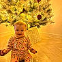 Vaiva is registered to the contest to win money with this photo: baby, celebration, child, christmas_tree, cute, decorations, festive, floor, happy, holiday, home, indoors, lights, ornaments, pajamas, seasonal, sitting, smiling, winter, wooden_floor