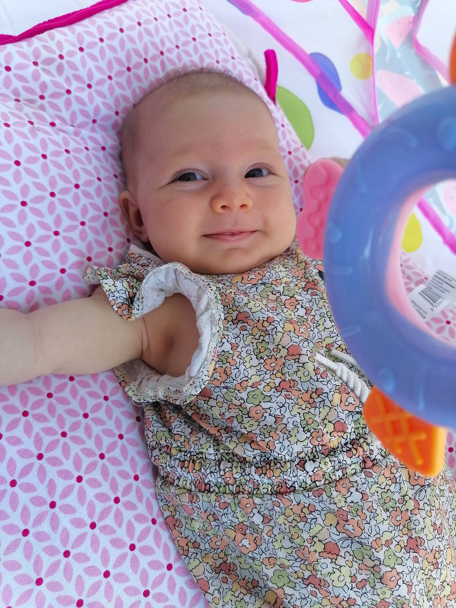 Faustine a rejoint le concours — aidez-le/la à gagner de superbes lots ! baby, baby_playing_with_toys, baby_toddler_clothing, child, design, eye, fun, happy, head, linens, magenta, pattern, person, pink, purple, skin, sleeve, smile, t_shirt, textile