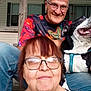 Booboo joined the competition — help win amazing prizes! adult, animal, black_and_white_dog, casual_clothing, dog, eyeglasses, facial_expression, happy, human, jeans, man, outdoor, pet, porch, portrait, sitting, smiling, window, woman, wooden_structure