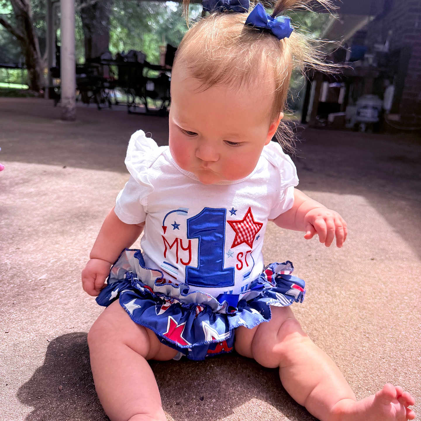 Ellie joined the competition — help win amazing prizes! baby, child, infant, sitting, outdoor, concrete, hair_bow, ponytails, white_shirt, colorful_skirt, number_1, stars, cute, sunlight, shadow, curious, chubby, legs, feet, portrait