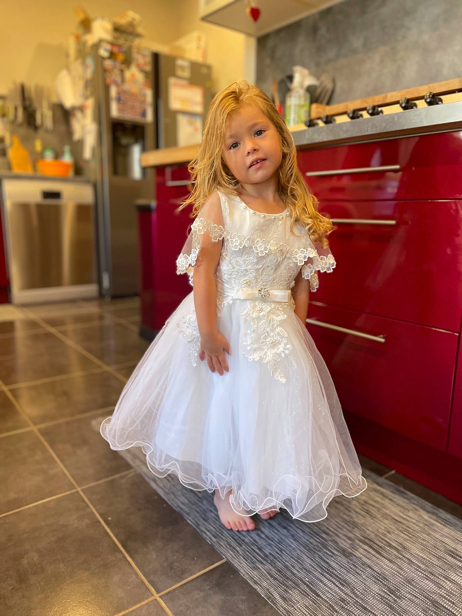 Lindsey participe au concours pour gagner de l'argent avec cette photo : bridal_clothing, bridal_party_dress, dress, event, fashion_design, flash_photography, floor, flooring, formal_wear, fun, gown, hair, happy, hardwood, long_hair, person, shoulder, smile, toddler, waist