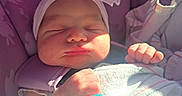 Adalyn is registered to the contest to win money with this photo: baby, newborn, sleeping, pacifier, headband, bow, car_seat, purple, blanket, infant, cute, peaceful, small_hands, wrapped, indoors, child, person, soft_light, nap, resting