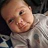 Adalyn joined the competition — help win amazing prizes! baby, infant, child, portrait, close_up, face, smile, eyes, lying_down, indoor, cozy, blanket, clothing, striped_outfit, ribbed_fabric, soft_lighting, home, relaxed, cute, photography