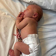 Ophelia-Rose is registered to the contest to win money with this photo: baby, beads, bed, child, closeup, cute, diaper, human, indoors, infant, lying_down, newborn, pacifier_clip, peaceful, pink_ribbon, rest, skin, sleeping, soft_light, white_sheet