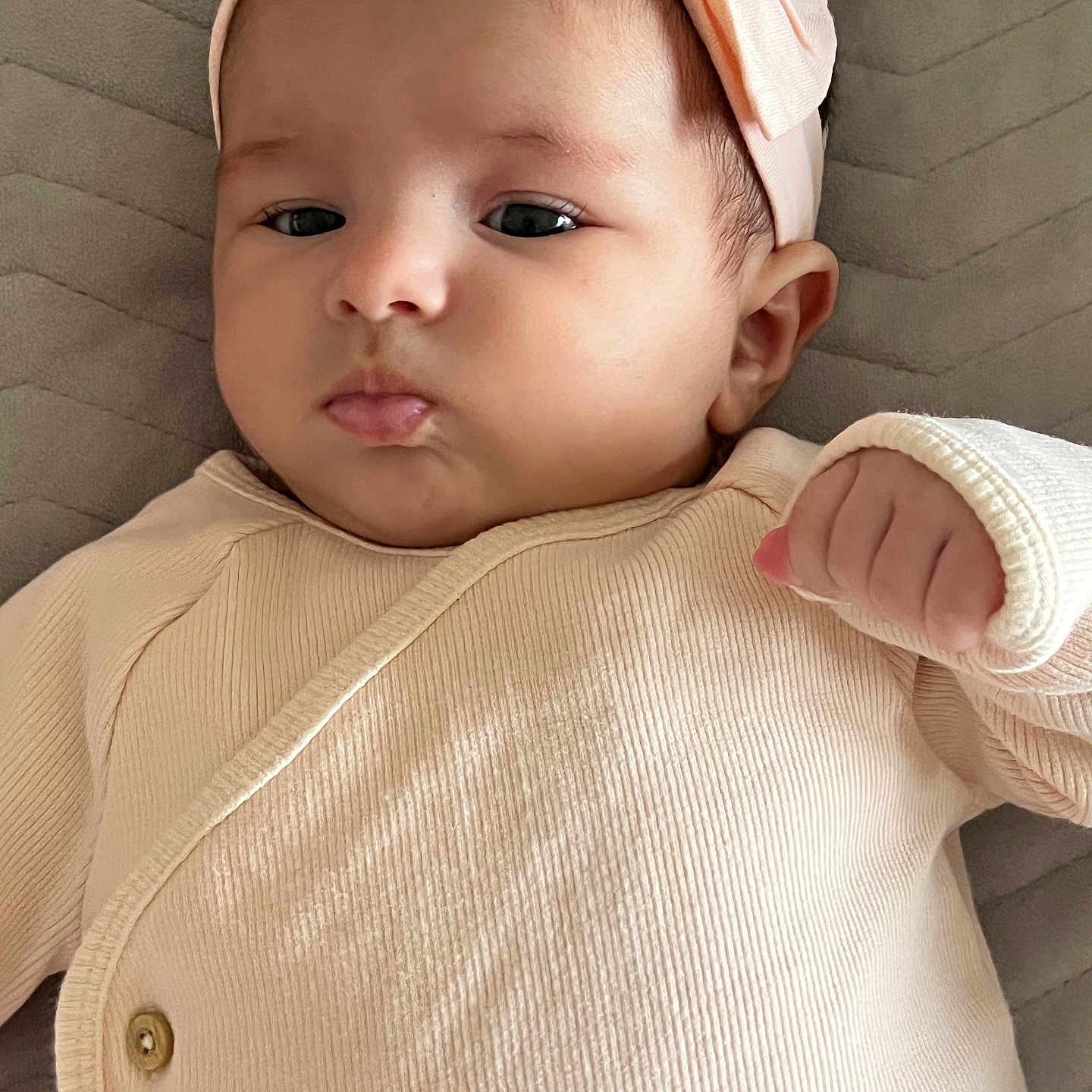 Laya Bailich participe au concours pour gagner de l'argent avec cette photo : apparel, baby, child, closeup, clothing, cute, fabric, face, hand, headband, indoors, infant, lying_down, newborn, pink, portrait, pout, quilted, skin, young_child