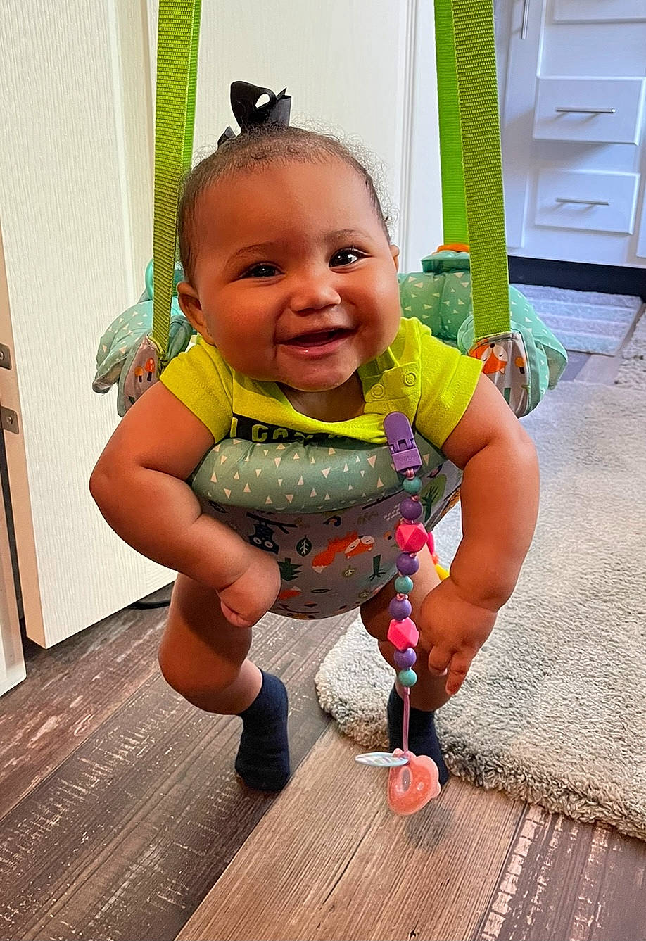 Khaleia Jo joined the competition — help win amazing prizes! baby, baby_toddler_clothing, child, floor, flooring, fun, happy, hardwood, joy, person, pink, purple, sitting, skin, smile, sunglasses, t_shirt, thumb, toddler, varnish