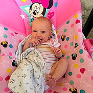 Lyra joined the competition — help win amazing prizes! baby, infant, blanket, pink, mickey_mouse, minnie_mouse, child, smiling, seat, polka_dots, stars, cute, happy, indoors, toddler, clothing, face, head, feet, hand