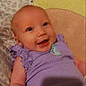 Lyra joined the competition — help win amazing prizes! baby, infant, smiling, purple_clothing, blanket, cushion, lying_down, happy, cute, face, child, indoors, patterned_blanket, patterned_cushion, skin, head, eyes, mouth, hand, newborn