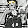 baby, child, denim_overalls, teddy_bear, bracelet, sunglasses_edit, cap_edit, blanket, patterned_blanket, black_and_white, cute, lying_down, infant, clothing, toy, playful, portrait, indoors, human, small_child
